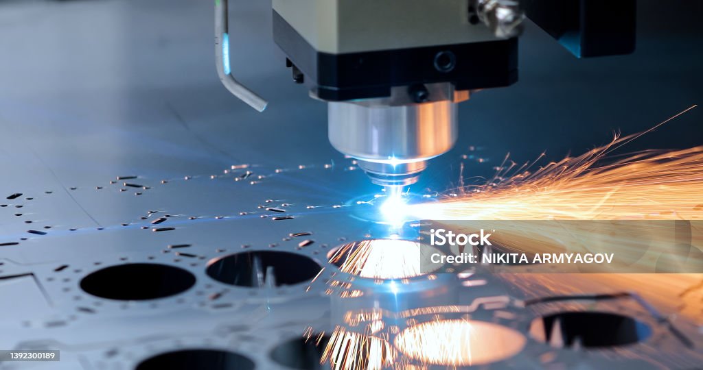 Laser cutter cutting metal with sparks