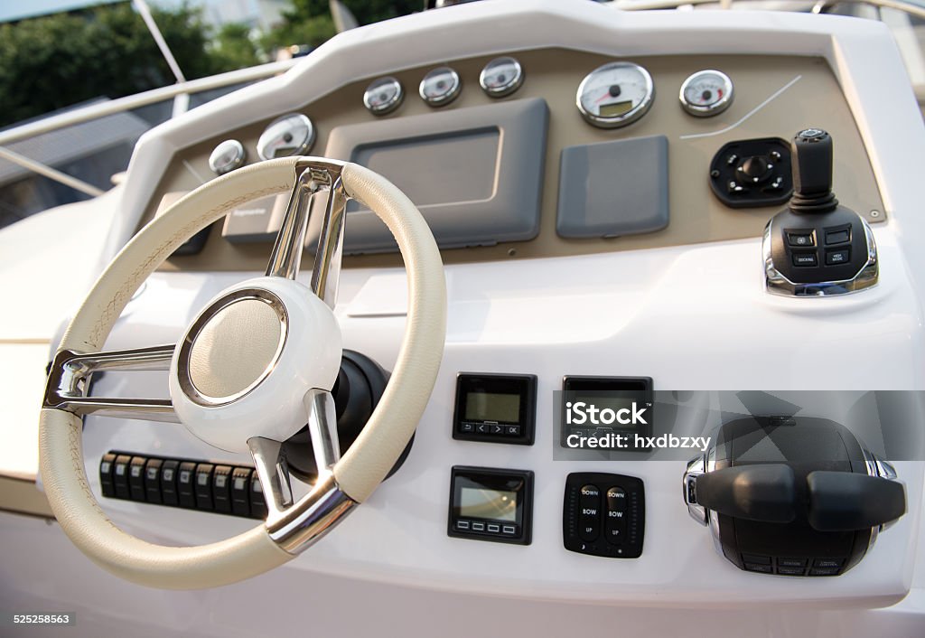Powerboat helm with steering wheel, gauges, and throttle controls