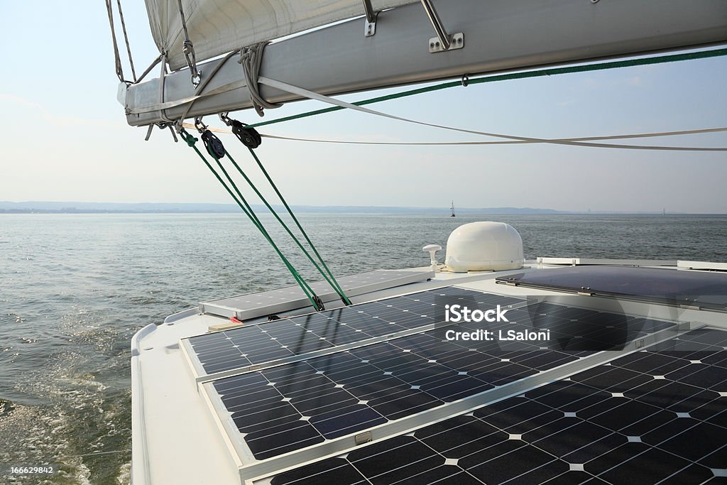 Solar panels charging batteries aboard a sailboat